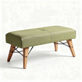 Green upholstered bench with wooden legs and metal accents 120 x 50 x 40cm